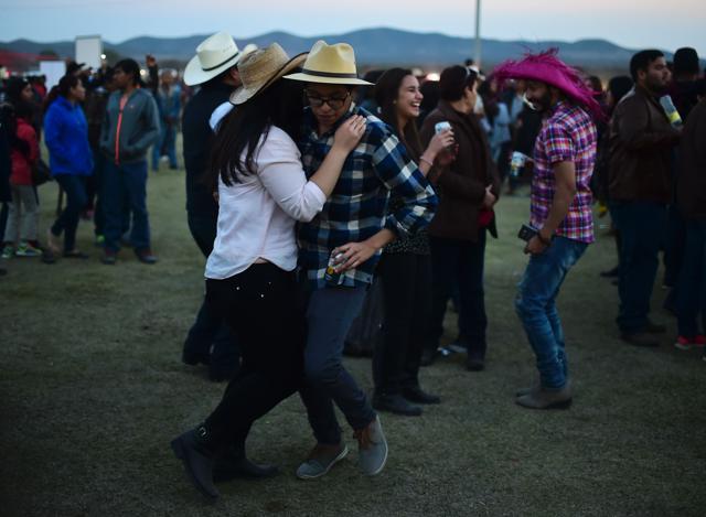 Revelers dance at Rubi’s birthday which was held on open grounds in Villa Guadalupe, San Luis Potosi State. The almost day-long event was a one-of-kind party that saw people travel from miles to participate in Rubi’s coming-of-age birthday celebration. (AFP)