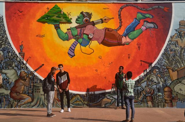 People take selfies in front of the mural, displayed at Mood Indigo, before it was covered by Shiv sainiks claiming indecency. (Prashant Waydande /HT)