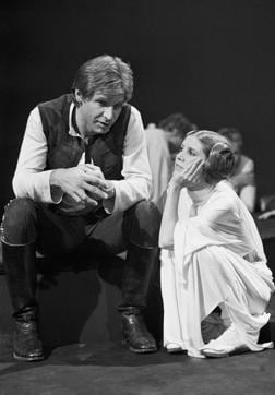 In this November 1978 photo, Harrison Ford – who plays Han Solo – with Carrie Fisher during a break in the filming of the CBS-TV special ‘The Star Wars Holiday’ in Los Angeles. Ford’s Solo and Fisher’s Leia played each other’s love interest in the Star Wars franchise. (AP) In this November 1978 photo, Harrison Ford – who plays Han Solo – with Carrie Fisher during a break in the filming of the CBS-TV special ‘The Star Wars Holiday’ in Los Angeles. Ford’s Solo and Fisher’s Leia played each other’s love interest in the Star Wars franchise. (AP)