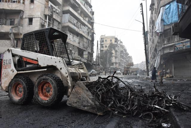 A tractor removes rubble as the Syrian government starts to clean up areas formerly held by opposition forces in the northern city of Aleppo on December 27, 2016, in the Shaar district. (AFP Photo)