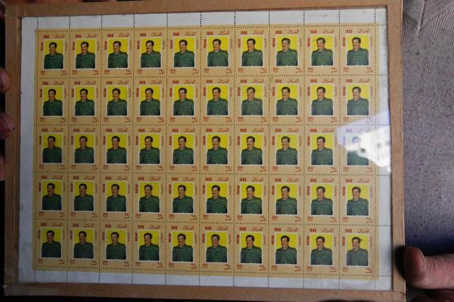 An Iraqi shopkeeper holds stamps bearing portraits of late Iraqi president Saddam Hussein at his shop in Baghdad. (AFP photo) An Iraqi shopkeeper holds stamps bearing portraits of late Iraqi president Saddam Hussein at his shop in Baghdad. (AFP photo)