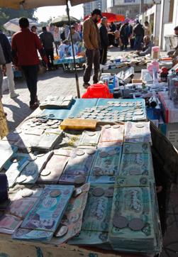 A stand at a market selling coins and notes bearing portraits of late Iraqi president Saddam Hussein in Baghdad. (AFP photo) A stand at a market selling coins and notes bearing portraits of late Iraqi president Saddam Hussein in Baghdad. (AFP photo)