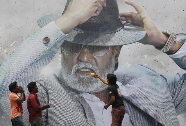Fans of Indian superstar Rajinikanth offer prayers in front of his poster outside a cinema hall to celebrate the screening of Kabali in Chennai, India, Friday, July 22, 2016. (AP) Fans of Indian superstar Rajinikanth offer prayers in front of his poster outside a cinema hall to celebrate the screening of Kabali in Chennai, India, Friday, July 22, 2016. (AP)