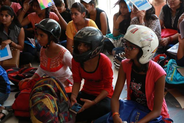 Students of Daulat Ram College participating in the helmet protest on college grounds. (Amal KS/HT Photo)