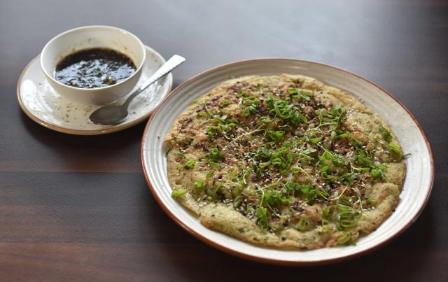 The Korean seafood pancake, with prawns, calamari, and scallions, is an interesting gluten-free, rice-flour alternative and is highly recommended. (Pratham Gokhale/HT PHOTO)