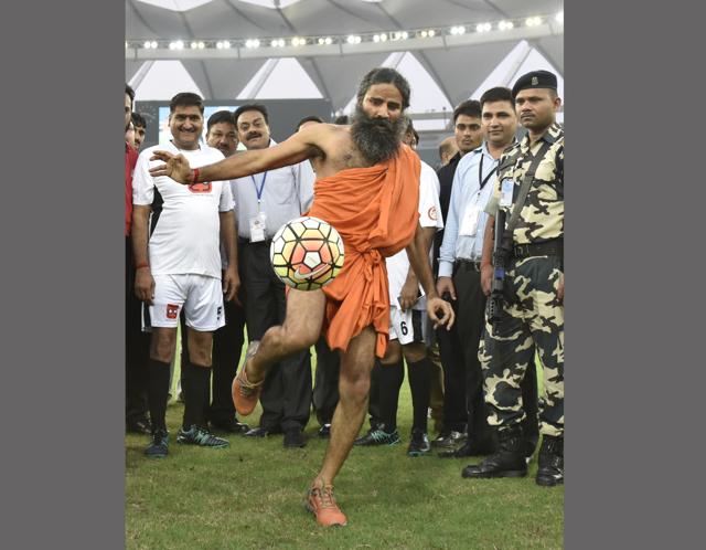 The Baba kicks a ball: Yoga guru Ramdev kicks a football during a charitable football match between Bollywood actors and Indian parliamentarians in New Delhi. It was a good year for Ramdev as Patanjali gave stiff competition to established FMCG companies and netted an annual turnover of Rs 5,000 crores. (Vipin Kumar/HT PHOTO)