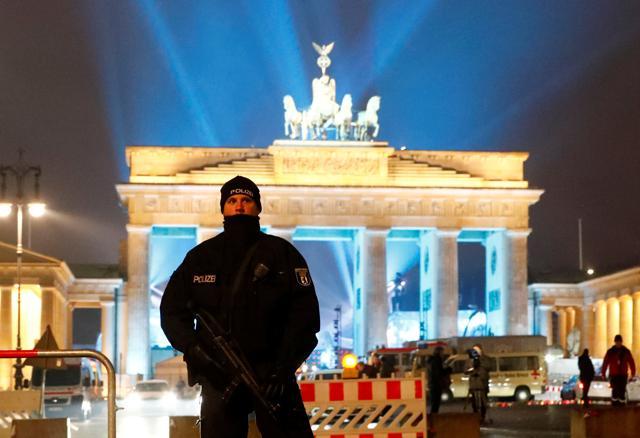 A German police man guards the venue at the Brandenburg Gate, during the upcoming New Year's Eve celebrations in Berlin. (REUTERS)