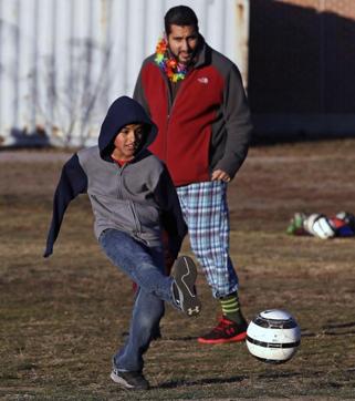 Syrian refugee Ahmad Alkhalaf plays soccer with friends during a day camp for local Muslim children in Sharon, Mass. The young boy who lost his arms in a refugee camp bomb blast is thriving in his new life in Massachusetts. (AP Photo) Syrian refugee Ahmad Alkhalaf plays soccer with friends during a day camp for local Muslim children in Sharon, Mass. The young boy who lost his arms in a refugee camp bomb blast is thriving in his new life in Massachusetts. (AP Photo)