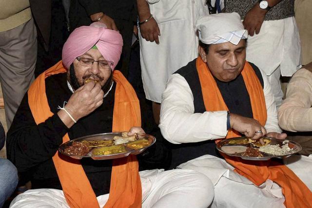 Punjab Congress chief Capt Amarinder Singh eating langar with party leader Shakeel Ahmad during the 350th birth anniversary celebration of Guru Gobind Singh at Gandhi Maidan in Patna on Tuesday. (PTI)