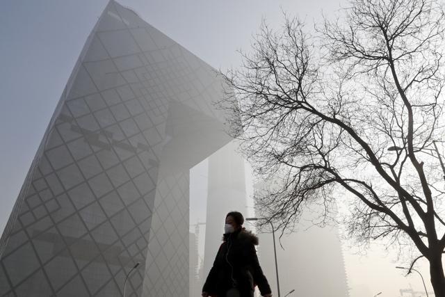 A Chinese woman wears a protection mask near the headquarters of China's state broadcaster Central China Television in Beijing on Tuesday as China is engulfed in heavy smog. (AP photo) A Chinese woman wears a protection mask near the headquarters of China's state broadcaster Central China Television in Beijing on Tuesday as China is engulfed in heavy smog. (AP photo)