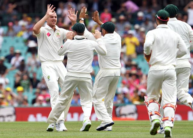Australia's paceman Josh Hazlewood (L) is congratulated by teammates after dismissing Pakistan batsman Sharjeel Khan during the second day of the third cricket Test match at the SCG in Sydney on Wednesday. (AFP)