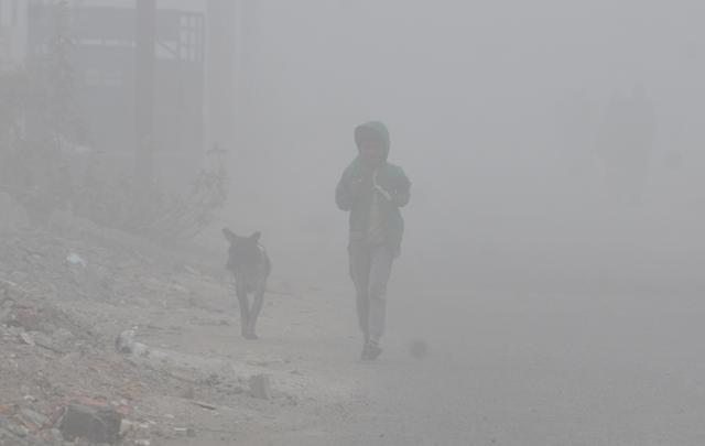 A boy jogging along with his pet on a foggy morning in Indore. (Shankar Mourya/HT photo) A boy jogging along with his pet on a foggy morning in Indore. (Shankar Mourya/HT photo)