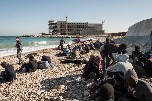 Illegal immigrants gather after their boat washed ashore in the Andalus district of Tripoli on Wednesday. (AFP photo) Illegal immigrants gather after their boat washed ashore in the Andalus district of Tripoli on Wednesday. (AFP photo)