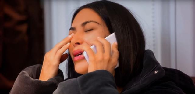 Kim crying over the phone as she talks to husband Kanye West in the promo. (YouTube)