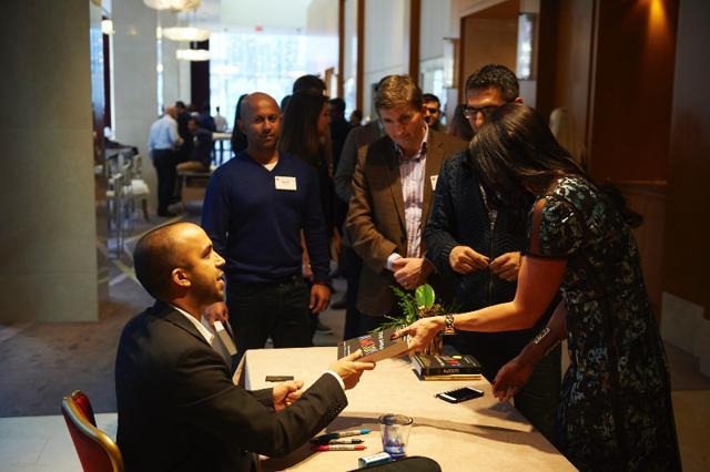 Neil Pasricha autographing a copy of his book. (HT PHOTO)