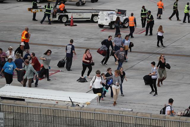 People seek cover on the tarmac of Fort Lauderdale-Hollywood International airport after a gunman opened fire near the baggage claim area on January 6, 2017 in Fort Lauderdale, Florida. (AFP) People seek cover on the tarmac of Fort Lauderdale-Hollywood International airport after a gunman opened fire near the baggage claim area on January 6, 2017 in Fort Lauderdale, Florida. (AFP)