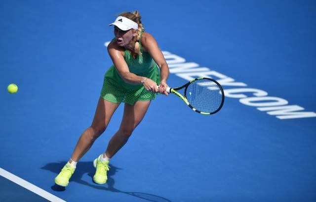 Caroline Wozniacki of Denmark hits a return to Monica Puig of Puerto Rico in their women's first round match at the Sydney International. (AFP) Caroline Wozniacki of Denmark hits a return to Monica Puig of Puerto Rico in their women's first round match at the Sydney International. (AFP)