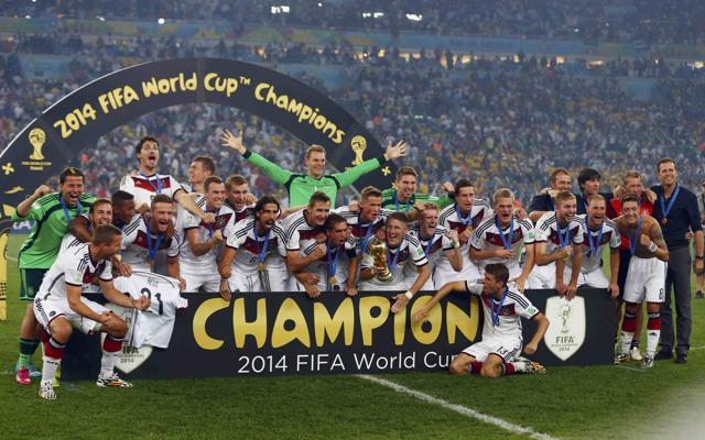 Germany's players pose for pictures as they celebrate with their World Cup trophy after beating Argentina at the Maracana stadium in Rio de Janeiro on July 13, 2014. (REUTERS)