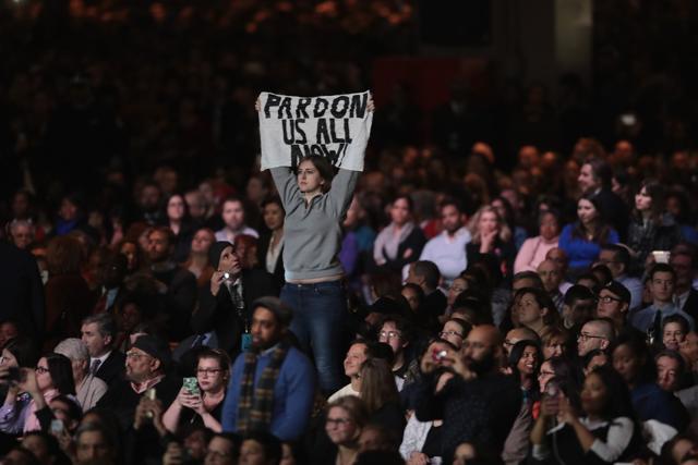A demonstrator holds up a banner as President Barack Obama delivers a farewell speech to the nation. (AFP Photo) A demonstrator holds up a banner as President Barack Obama delivers a farewell speech to the nation. (AFP Photo)