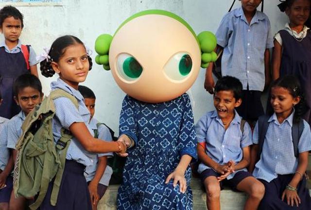 The petite 35-year-old always wears the head of a noseless, doe-eyed, green-haired homegrown cartoon.