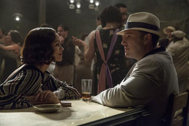 Affleck, as a rum-running Irish hood, sees his path crisscross with those of several beautiful women, including a Cuban senorita (Zoe Saldana, above) and a born-again evangelist played by Elle Fanning. Affleck, as a rum-running Irish hood, sees his path crisscross with those of several beautiful women, including a Cuban senorita (Zoe Saldana, above) and a born-again evangelist played by Elle Fanning.