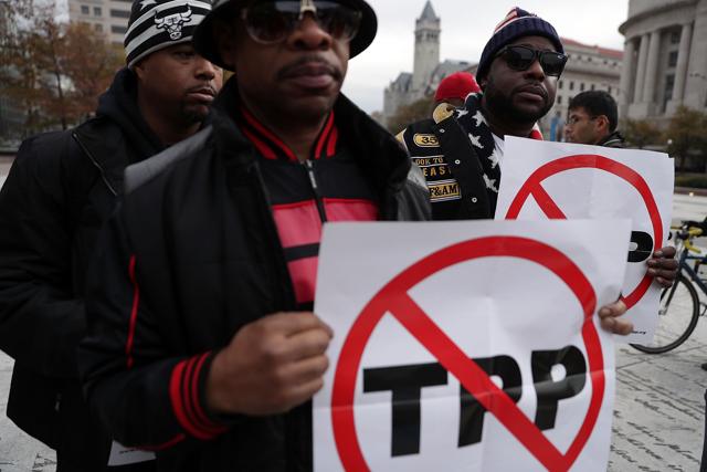 Activists hold signs as they rally during an anti-TPP protest in Washington, DC. Activists held a rally and a march "to protest the Trans-Pacific Partnership.” (AFP Photo) Activists hold signs as they rally during an anti-TPP protest in Washington, DC. Activists held a rally and a march "to protest the Trans-Pacific Partnership.” (AFP Photo)