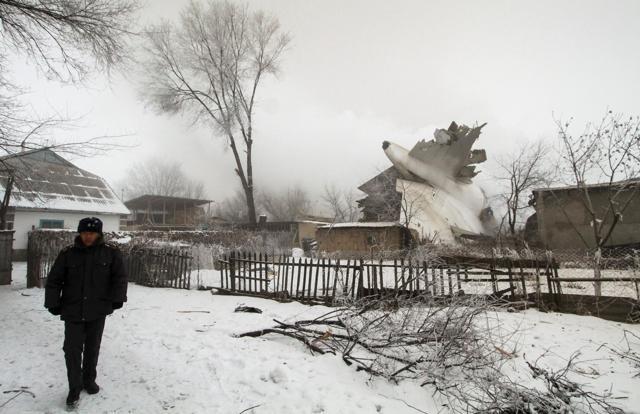 A policeman guards an area at the crash site of a Turkish cargo jet. (REUTERS) A policeman guards an area at the crash site of a Turkish cargo jet. (REUTERS)
