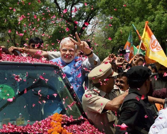 Prime Minister-elect Narendra Modi waves victory sign to the supporters during a road show after his arrival in New Delhi. (PTI file) Prime Minister-elect Narendra Modi waves victory sign to the supporters during a road show after his arrival in New Delhi. (PTI file)