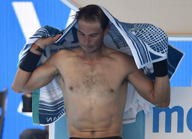 Rafael Nadal uses a towel to wipe sweat during a break as he plays Germany's Florian Mayer in their first round match at the Australian Open in Melbourne on Tuesday. (AP) Rafael Nadal uses a towel to wipe sweat during a break as he plays Germany's Florian Mayer in their first round match at the Australian Open in Melbourne on Tuesday. (AP)