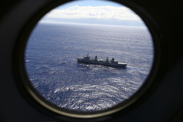 In this March 31, 2014 file photo, HMAS Success scans the southern Indian Ocean, near the coast of Western Australia, as a Royal New Zealand Air Force P3 Orion flies over in the search for missing Malaysia Airlines Flight MH370. (AP) In this March 31, 2014 file photo, HMAS Success scans the southern Indian Ocean, near the coast of Western Australia, as a Royal New Zealand Air Force P3 Orion flies over in the search for missing Malaysia Airlines Flight MH370. (AP)
