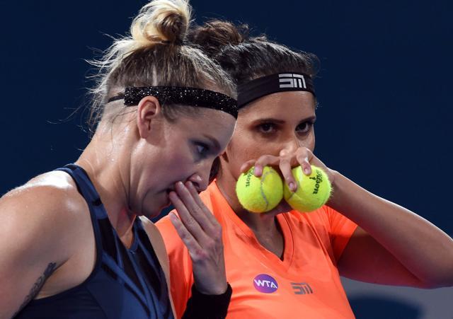 Sania Mirza (R) of India and Bethanie Mattek-Sands of the US talk between points against Russia's Ekaterina Makarova and Elena Vesnina in their women's doubles final match at the Brisbane International tennis tournament on January 7, 2017. (AFP)