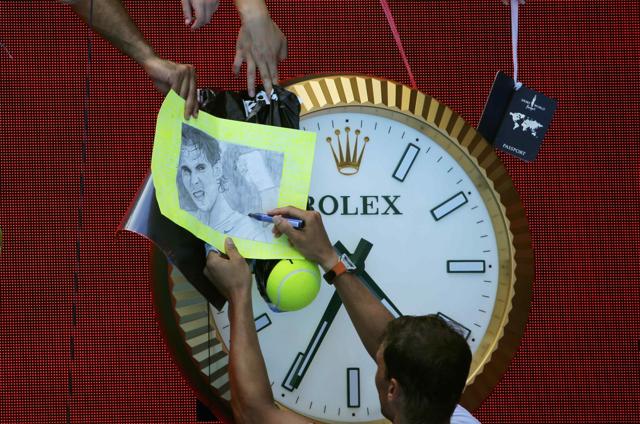 Rafael Nadal signs autographs at Melbourne Park on Tuesday. (REUTERS) Rafael Nadal signs autographs at Melbourne Park on Tuesday. (REUTERS)