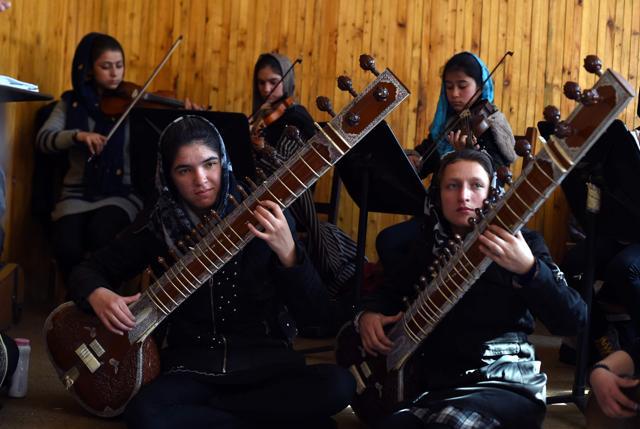 Afghan girls playing sitars and violins during rehearsal ahead of their perforamance at Davos. (AFP Photo) Afghan girls playing sitars and violins during rehearsal ahead of their perforamance at Davos. (AFP Photo)