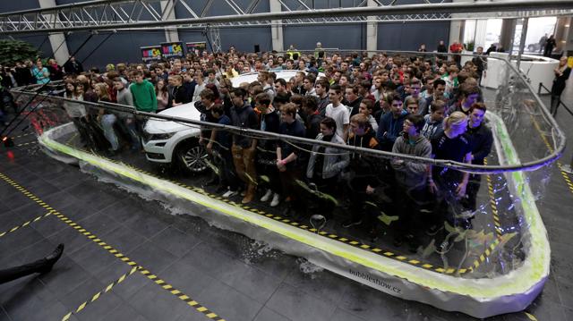 275 participants and a car stand inside a soap bubble to achieve the Guinness World Record for the most people surrounded by a soap bubble in Mlada Boleslav, Czech Republic. (REUTERS)