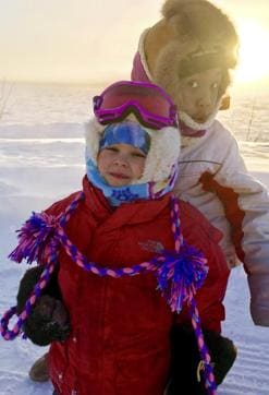 Carrie and Cuppy Agnes stand for a photo in front of the frozen Yukon River in Tanana, Alaska. (AP Photo) Carrie and Cuppy Agnes stand for a photo in front of the frozen Yukon River in Tanana, Alaska. (AP Photo)