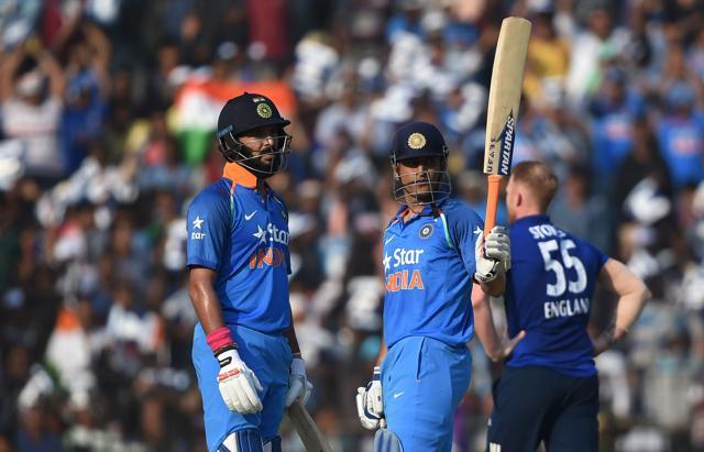 Mahendra Singh Dhoni raises his bat after completing his half century as Yuvraj Singh looks on during the second One Day International cricket between India and England at the Barabati Stadium in Cuttack on Thursday. (AFP) Mahendra Singh Dhoni raises his bat after completing his half century as Yuvraj Singh looks on during the second One Day International cricket between India and England at the Barabati Stadium in Cuttack on Thursday. (AFP)