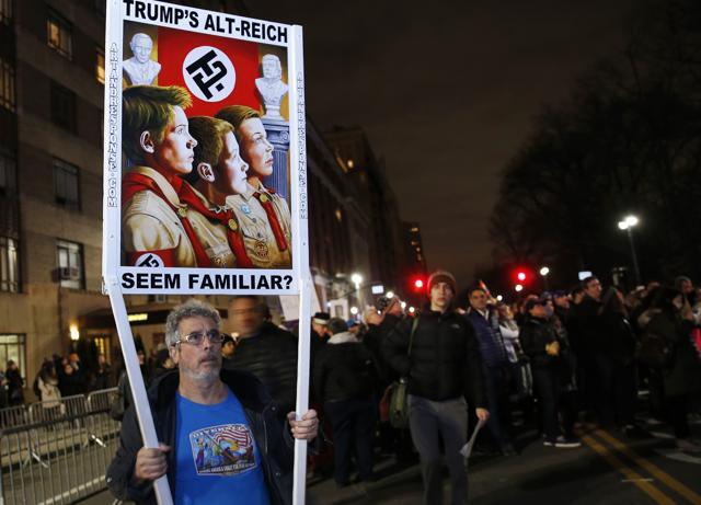 A protester holds a sign making a play on words about the alt-Right movement at an anti-Trump rally and protest in front of the Trump International Hotel in New York on Thursday. (AP)