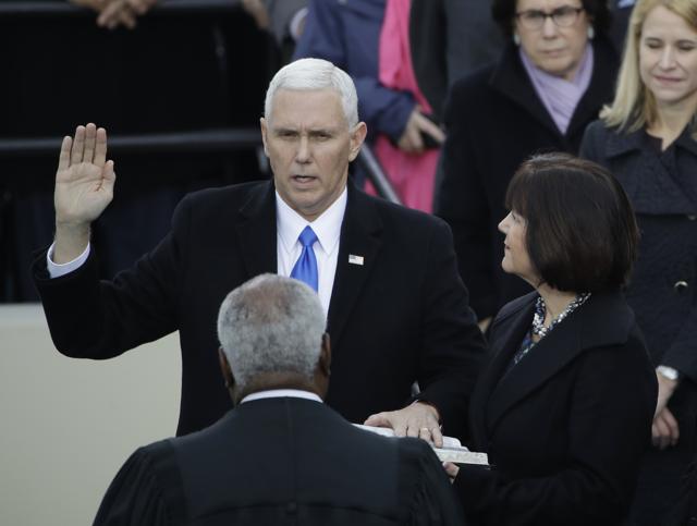 Vice president Mike Pence takes his oath of office during the 58th Presidential Inauguration at the US Capitol in Washington. (AP) Vice president Mike Pence takes his oath of office during the 58th Presidential Inauguration at the US Capitol in Washington. (AP)