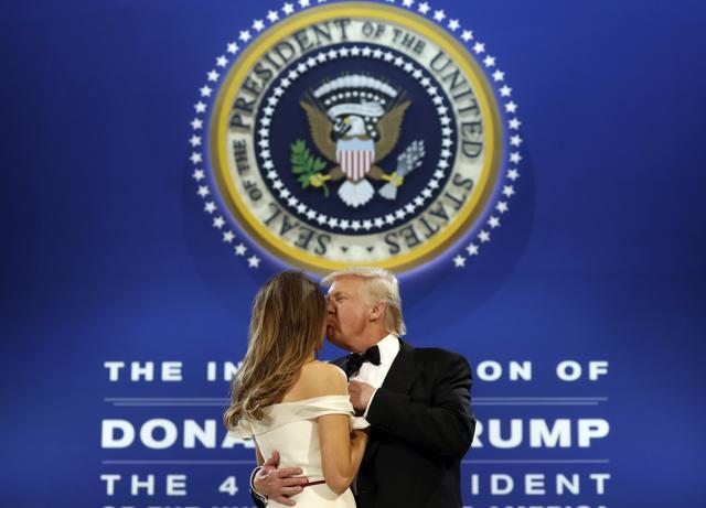 President Donald Trump kisses first lady Melania Trump as they dance at the The Salute To Our Armed Services Inaugural Ball in Washington. (AP Photo)