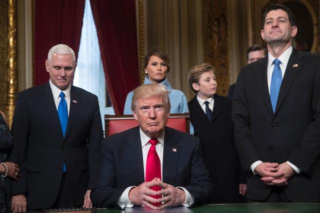 US President Donald Trump is joined by the Congressional leadership and his family before formally signing his cabinet nominations into law, in the President's Room of the Senate, at the Capitol in Washington,DC on January 20, 2017. From left are Vice President Mike Pence, the president's wife Melania Trump, their son Barron Trump, and Speaker of the House Paul Ryan, R-WI. (AFP Photo)
