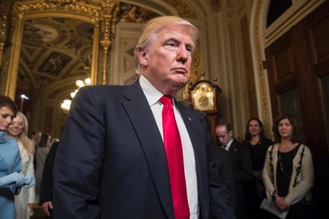US President Donald Trump leaves the President's Room of the Senate at the Capitol after he formally signed his cabinet nominations into law. (AFP Photo)