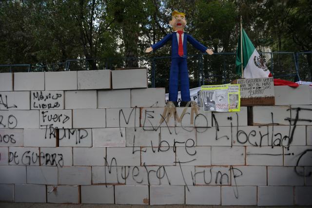 A symbolic wall and a pinata representing the U.S. President Donald Trump is seen during a protest outside the U.S. embassy, in Mexico City, Mexico January 20, 2017. REUTERS/Edgard Garrido (REUTERS)