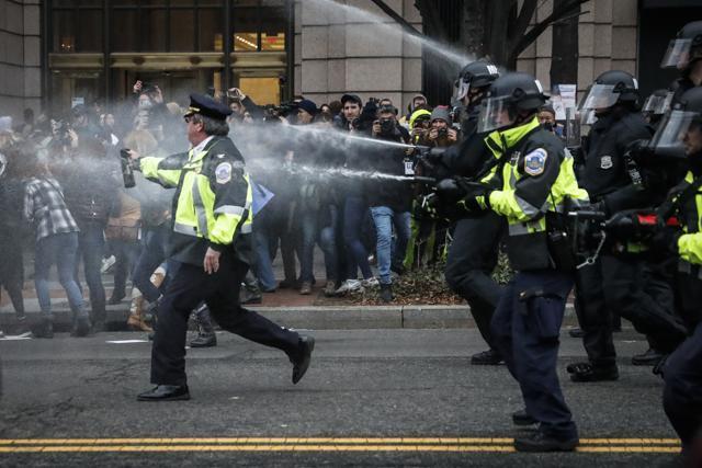 Police fire pepper spray on protestors during a demonstration after the inauguration of President Donald Trump, Friday, Jan. 20, 2017, in Washington. (AP Photo/John Minchillo) (AP)