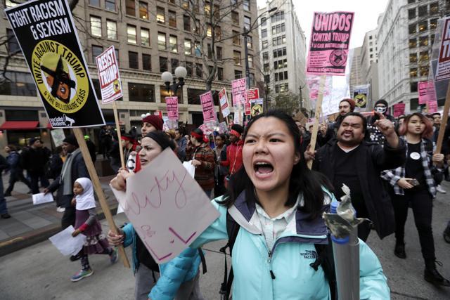 A coalition of students, immigrants, refugees and supporters fill a downtown street as they head to a rally while protesting on Inauguration Day, Friday, Jan. 20, 2017, in Seattle. (AP Photo/Elaine Thompson) (AP)
