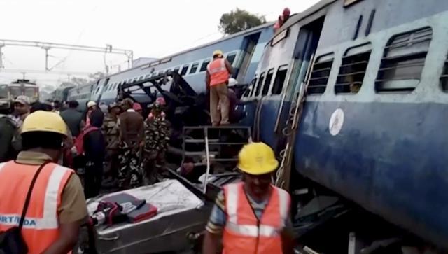 In this image from video, rescuers work around coaches of a derailed passenger train in Kuneru, Andhra Pradesh. (AP)
