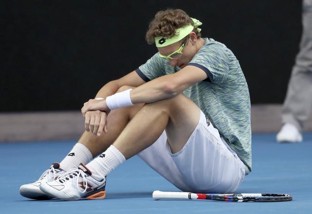Uzbekistan's Denis Istomin sits on the court after falling during his fourth round match against Bulgaria's Grigor Dimitrov at the Australian Open. (AP) Uzbekistan's Denis Istomin sits on the court after falling during his fourth round match against Bulgaria's Grigor Dimitrov at the Australian Open. (AP)
