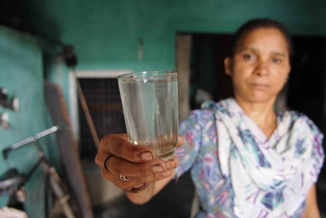 A woman shows contaminated water at Jhanjeri village, SAS Nagar. (Keshav Singh/HT Photo) A woman shows contaminated water at Jhanjeri village, SAS Nagar. (Keshav Singh/HT Photo)