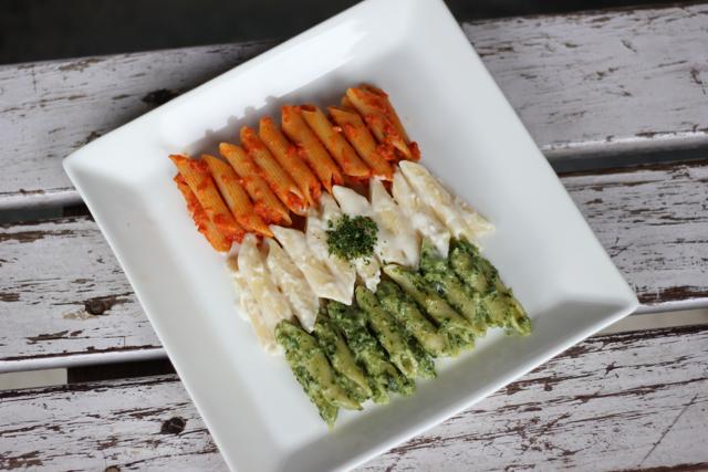 A tricolour pasta has all three variants: red sauce, white sauce and pesto. A tricolour pasta has all three variants: red sauce, white sauce and pesto.