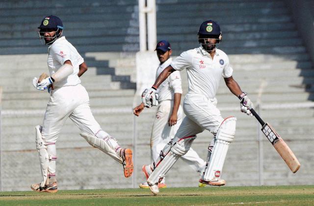 Cheteshwar Pujara (left) and Wriddhiman Saha of Rest India in action during the Irani Trophy match against Gujarat in Mumbai on Monday. The duo produced a match-winning 316 runs for the fifth wicket (PTI)