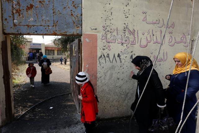 Parents of schoolchildren walk to register their children in school in Mosul, Iraq. (Reuters Photo) Parents of schoolchildren walk to register their children in school in Mosul, Iraq. (Reuters Photo)